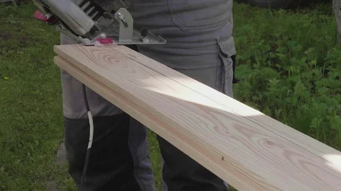 Carpenter cuts board with circular saw. Slow motion view. Stock Footage 76464701