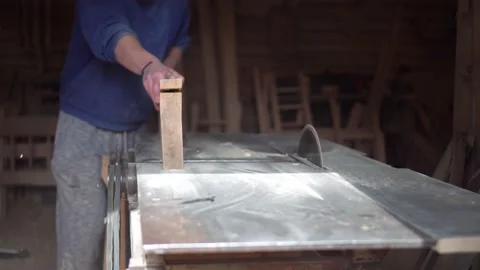 The carpenter cuts the board on a circular saw . Furniture factory Stock Footage 152396154