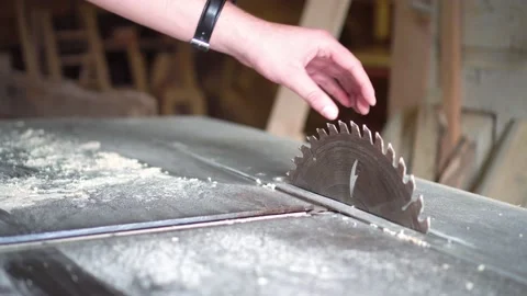 The carpenter cuts the board on a circular saw . Furniture factory Stock Footage 152400912