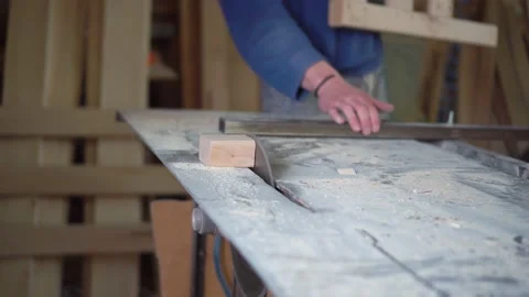 The carpenter cuts the board on a circular saw . Furniture factory Stock Footage 152402335