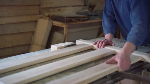 The carpenter cuts the board on a circular saw . Furniture factory Stock Footage 152402344