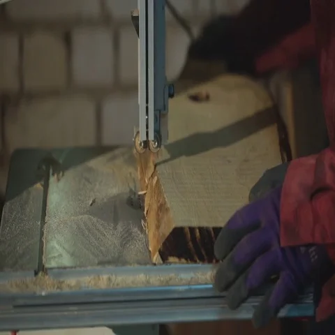 Carpenter cuts the board on rotating circular saw blade - Worker hands Stock Footage 69486343