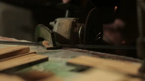 Carpenter cuts an iron bar with an angle grinder creating sparks. Stock Footage 100983955