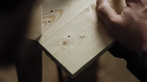 Carpenter cuts out a dovetail on a pine board with a hand saw. Stock Footage 166340798