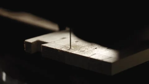 A carpenter cuts out a dovetail on a pine board with a hand jigsaw. dovetail  Stock Footage 166340804