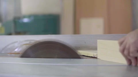 A carpenter cuts a wood plank using an electric saw, slow motion Stock Footage 133139508