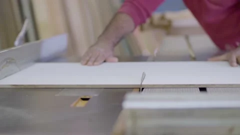 A carpenter cuts a wood plank using an electric saw Stock Footage 133283600