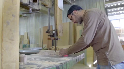 A carpenter cuts a wood plank using an electric saw, slow motion Stock Footage 141165002