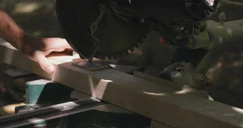 Carpenter cuts wood using miter saw Stock Footage 159743775