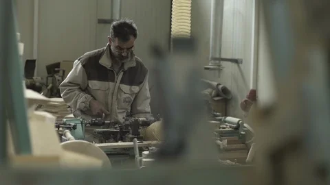 Carpenter cutting and drilling timber on lathe machine, shallow depth of field. Stock Footage 88217855