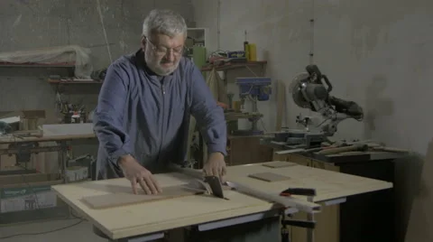 Carpenter cutting board on circular table saw in workshop, making wooden box. Stock Footage 57741232