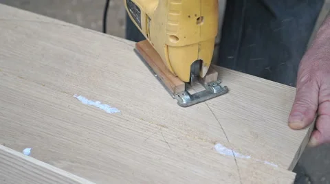 Carpenter is cutting a board with fretsaw Stock Footage 67511119
