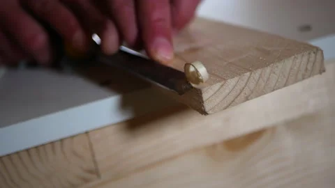 Carpenter cutting a chamfer in a pine wood board Stock Footage 155572978
