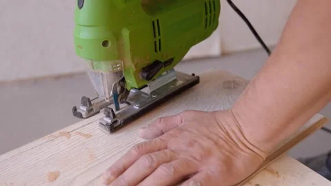 Carpenter cutting laminate flooring with electric jigsaw Stock Footage 326143053