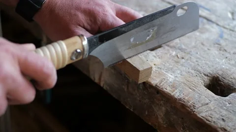 Carpenter cutting a piece of small oak wood Stock Footage 161638088