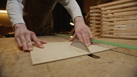 Carpenter Cutting Plywood Sheet with Table Saw in Woodworking Shop Stock Footage 340396189