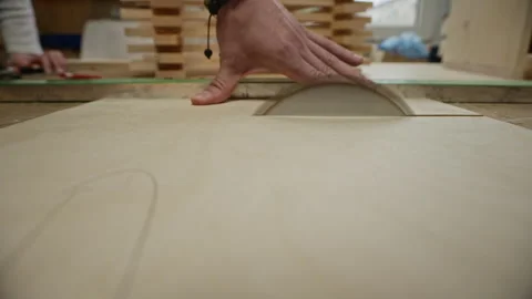 Carpenter Cutting Plywood Sheet with Table Saw in Workshop Stock Footage 340396345