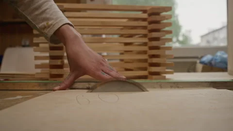 Carpenter Cutting Plywood Sheet Using Table Saw in Workshop Stock Footage 340396348