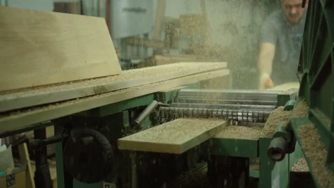 Carpenter Cutting Wood plank on machine make Sawdust slow motion Stock Footage 77669950