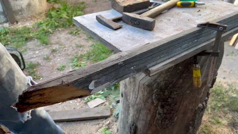 Carpenter cutting wood plank using circular saw Stock Footage 302384714