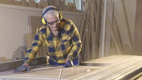 The carpenter is cutting wood in the workshop, working. 스톡 동영상 221635187