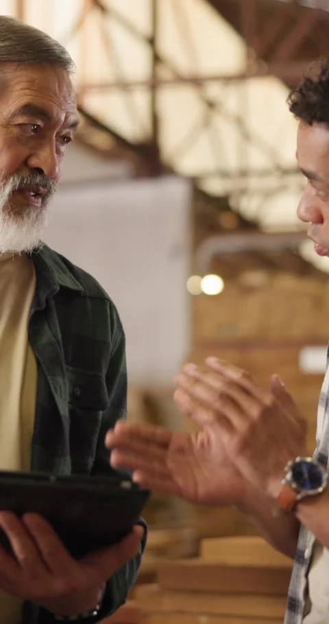 Carpenter, discussion and men with tablet in workshop, teamwork or planning for Stock Footage 340957943