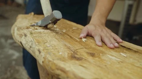 Carpenter doing handmade carpentry on a wooden log Stock Footage 266864825