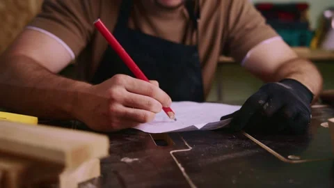 Carpenter drawing sketch on paper in workshop Stock Footage 308933141