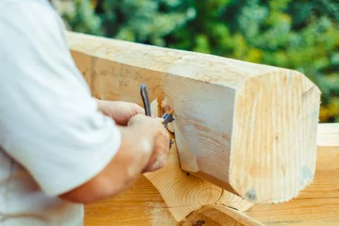 The carpenter is drawing on a tree Stock Photos