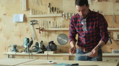 Carpenter draws the project in a carpentry workshop Stock Footage 61361808