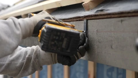Carpenter Driling A Screw into a plank With A Dewalt Drill Stock Footage 235793810