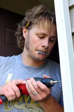 Carpenter drilling hole Stock Photos