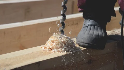 Carpenter is drilling timber wood and hammer nail at wooden house construction. Stock Footage 101753321