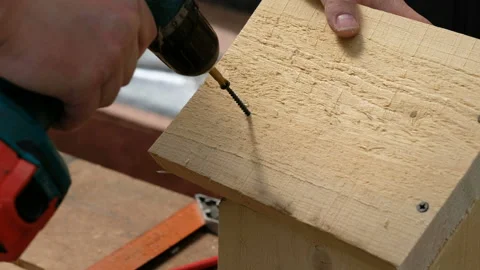 Carpenter drilling wood using portable drilling machine. Battery screwdriver or Stock Footage 108140772