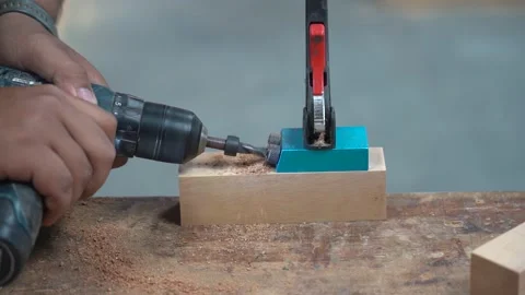 Carpenter drills a hole with an electrical drill Stock Footage 236896406