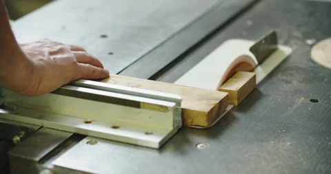 Carpenter engaged in his work. Wood cutting on the machine. Male hands close up Stock Footage 167819792