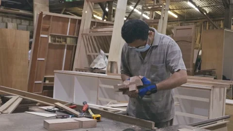 Carpenter with face mask on working alone at his studio during COVID-19 Stock Footage 137029616