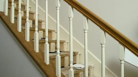Carpenter fitting in new risers to a home staircase Stock Footage 50868203