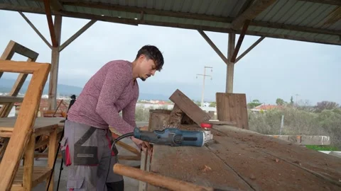 Carpenter fixing a chestnut log on a workbench for cutting Stock Footage 325206642