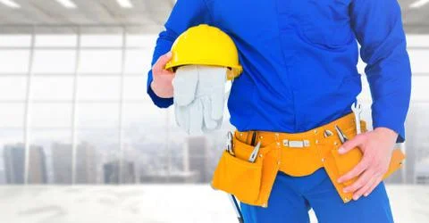 Carpenter with gloves against window background Stock Photos
