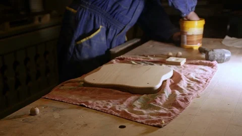 Carpenter glues the legs on the kitchen Board on the workbench Stock Footage 100865874