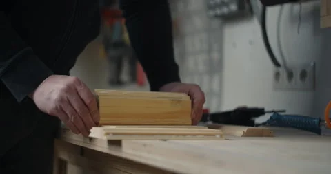Carpenter glues the timber billets, craftsman at workshop, gluing wood surfaces Stock Footage 149739204