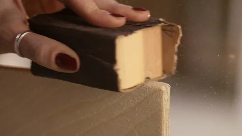 Carpenter grinding down a piece of wood Stock Footage 101342300