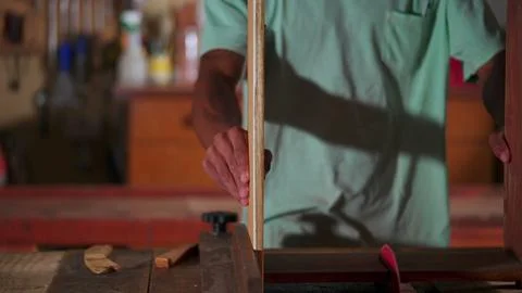 Carpenter Guiding Apprentice at Carpentry Workshop, Teaching Woodwork Using.. Stock Photos