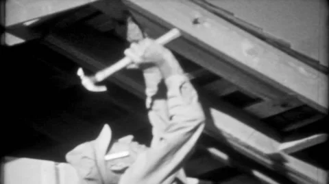 Carpenter hammers nails on home construction 1950s vintage film home movie 1890 Stock Footage 47883068