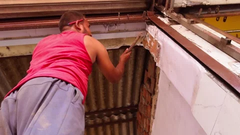 Carpenter handles glass frame inside workspace Stock Footage 312724020
