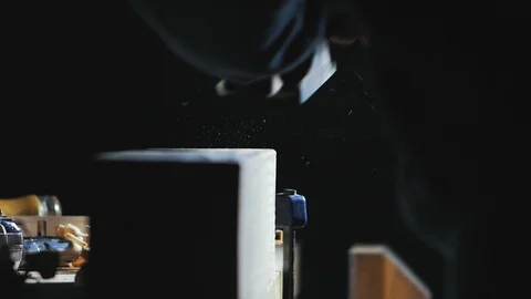 Carpenter handles a wooden board with a plane Stock Footage 102215341
