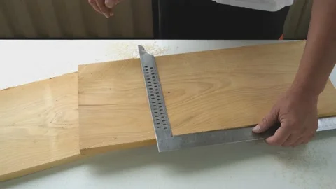 Carpenter hands mark wooden board by draw saw line,pencil,construction square Stock Footage 157116241