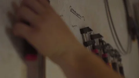 Carpenter hanging up tools on the wall after work day Stock Footage 76109124