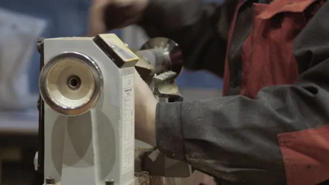 The carpenter with the help of a tool gives shape to wooden blanks on a machine. Stock Footage 218595095